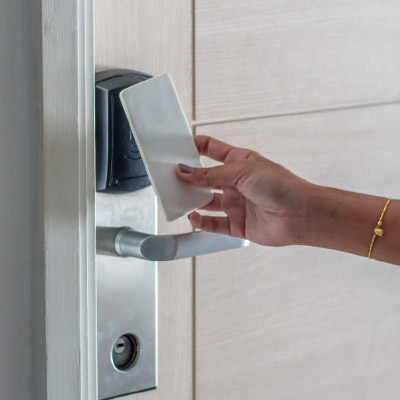 Person tapping key card on an access control unit.