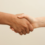two people shaking hands and working together